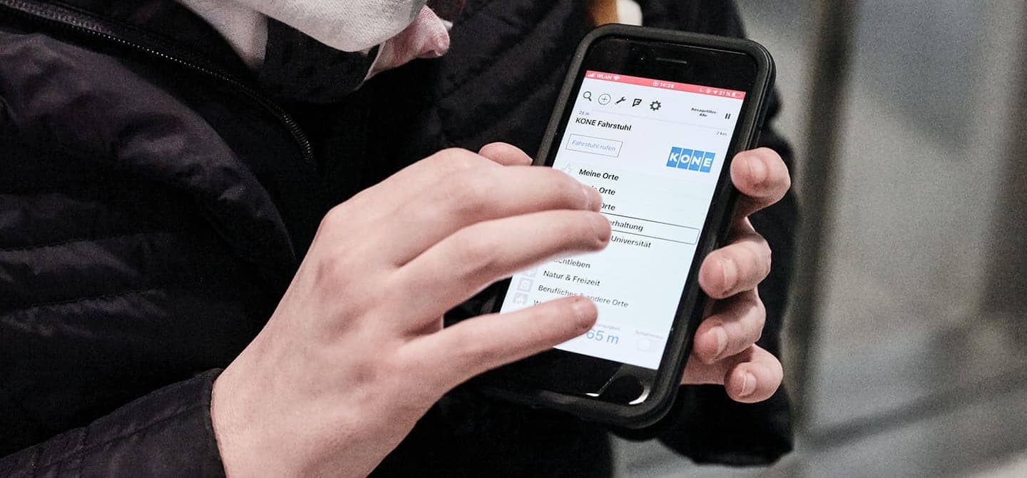 A woman who is blind using the BlindSquare application on her mobile phone.